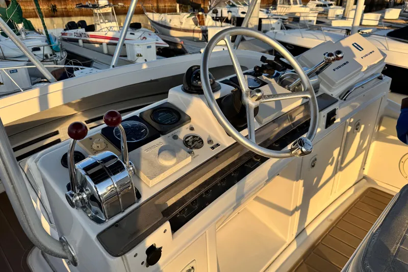 Slide: The Image of 1998 Luhrs Tournament 320 Convertible boat helm with steering wheel and control panel. - 10
