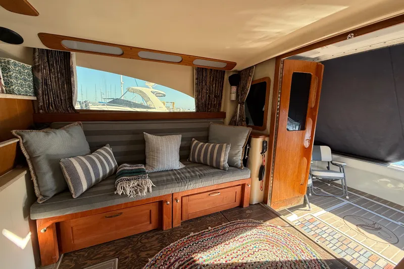 Slide: The Image of Interior of 1998 Luhrs Tournament 320 Convertible with cozy seating and nautical decor. - 16