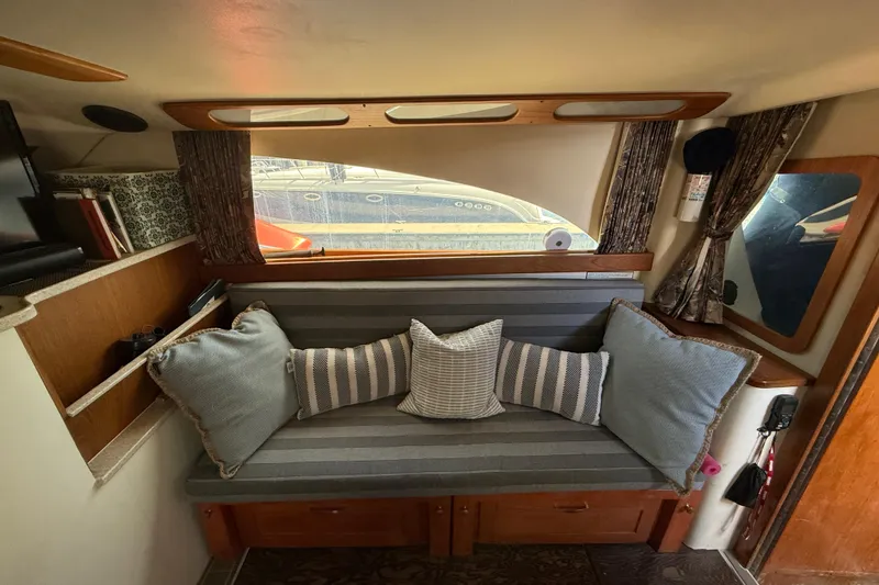 Slide: The Image of Interior of 1998 Luhrs Tournament 320 Convertible with cozy seating and decorative pillows. - 17