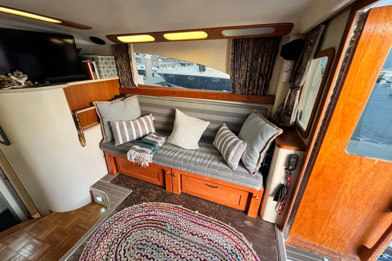 Slide: The Image of Interior of 1998 Luhrs Tournament 320 Convertible with cozy seating and decorative pillows. - 21
