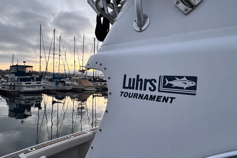 Slide: The Image of 1998 Luhrs Tournament 320 Convertible boat docked at marina during sunset. - 6