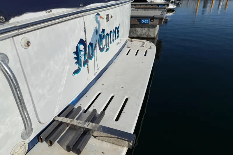 Slide: The Image of 1998 Luhrs Tournament 320 Convertible boat docked, featuring "No Egrets" graphic on the side. - 7