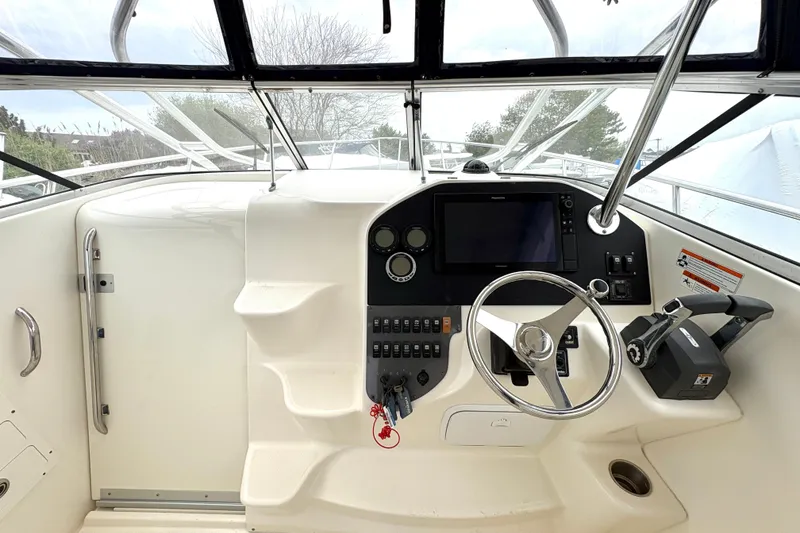 Slide: The Image of 2008 Seaswirl Striper 2901 Walkaround O/B helm with steering wheel and control panel. - 1