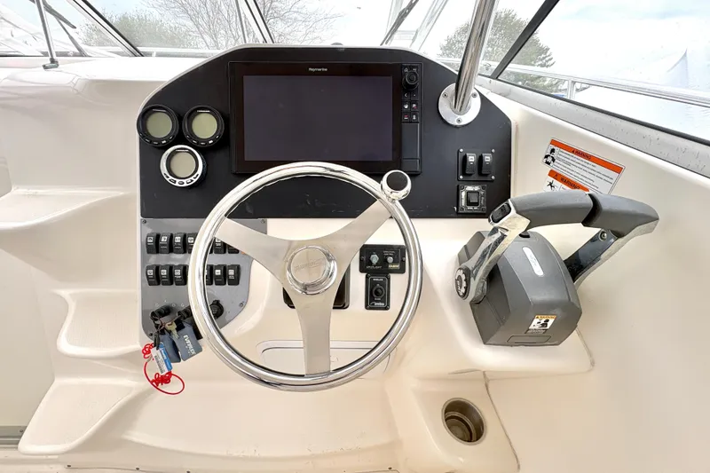 Slide: The Image of 2008 Seaswirl Striper 2901 Walkaround O/B helm with steering wheel and control panel. - 2