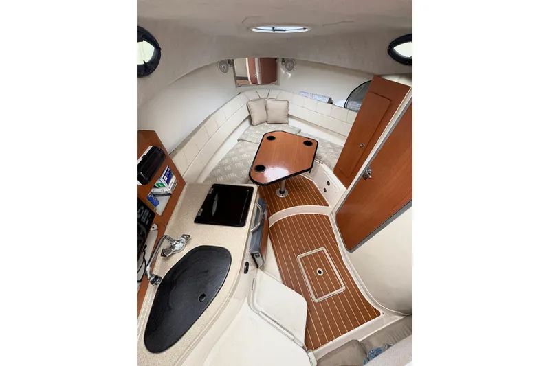 Slide: The Image of 2008 Seaswirl Striper 2901 Walkaround O/B cabin interior with kitchenette and seating area. - 7