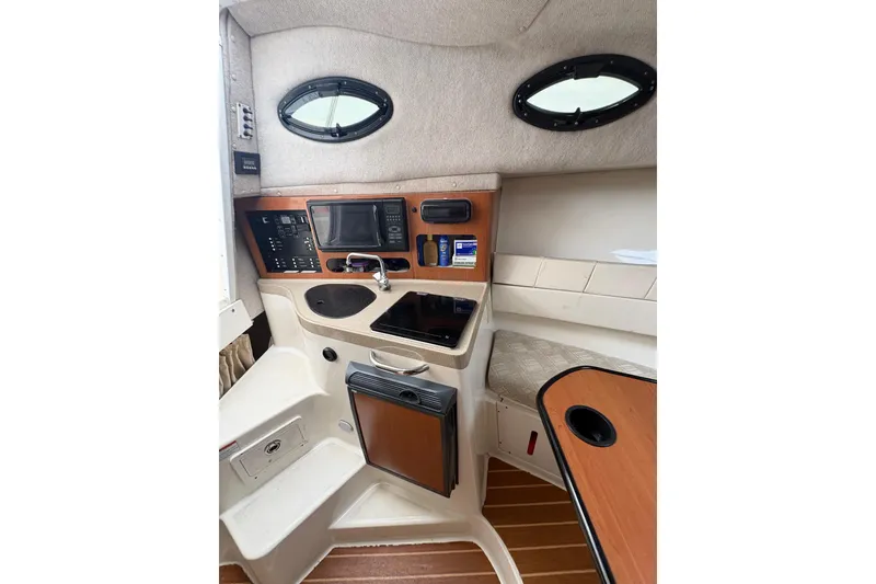 Slide: The Image of 2008 Seaswirl Striper 2901 Walkaround O/B cabin interior with control panel and seating. - 9