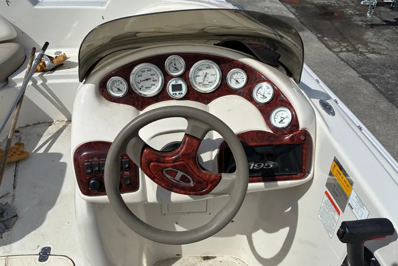 Slide: The Image of Steering console of a 2006 Tahoe 195 I/O boat with gauges and controls. - 5