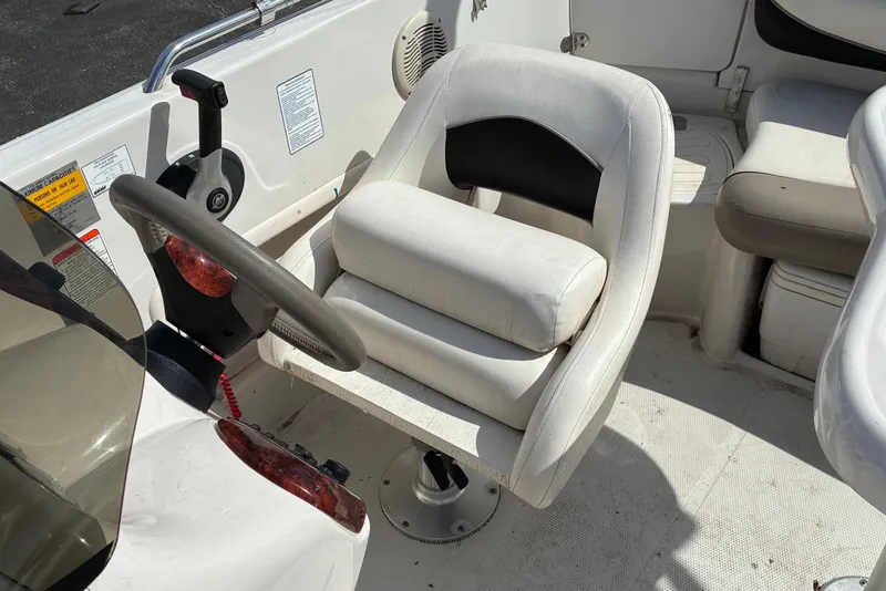 Slide: The Image of 2006 Tahoe 195 I/O boat interior with steering wheel and white captain's chair. - 6