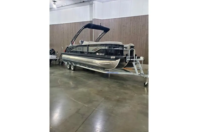 The Image of 2024 Barletta Corsa 23UA pontoon boat on trailer in indoor showroom. - 0