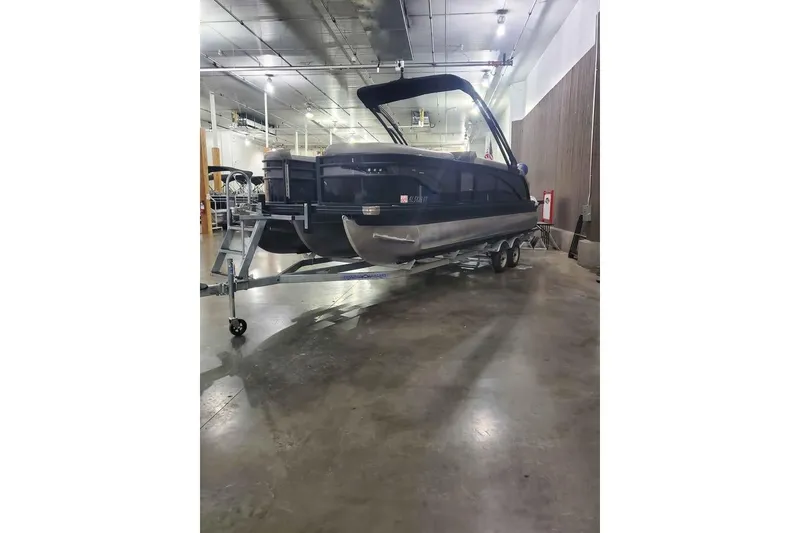 Slide: The Image of 2024 Barletta Corsa 23UA pontoon boat on trailer in indoor storage facility. - 3