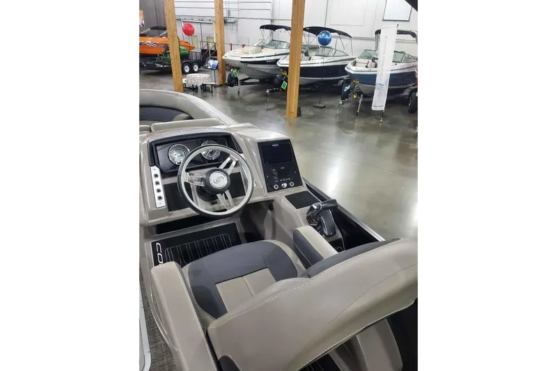 Slide: The Image of 2024 Barletta Corsa 23UA boat interior with modern dashboard and steering wheel. - 8