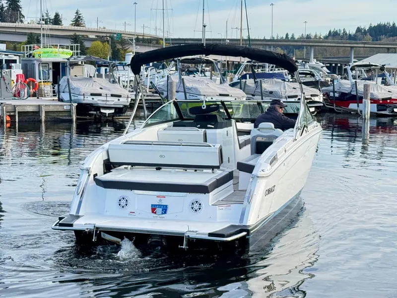 Slide: The Image of 2023 Cobalt R8 boat cruising in a marina, surrounded by other docked boats. - 16