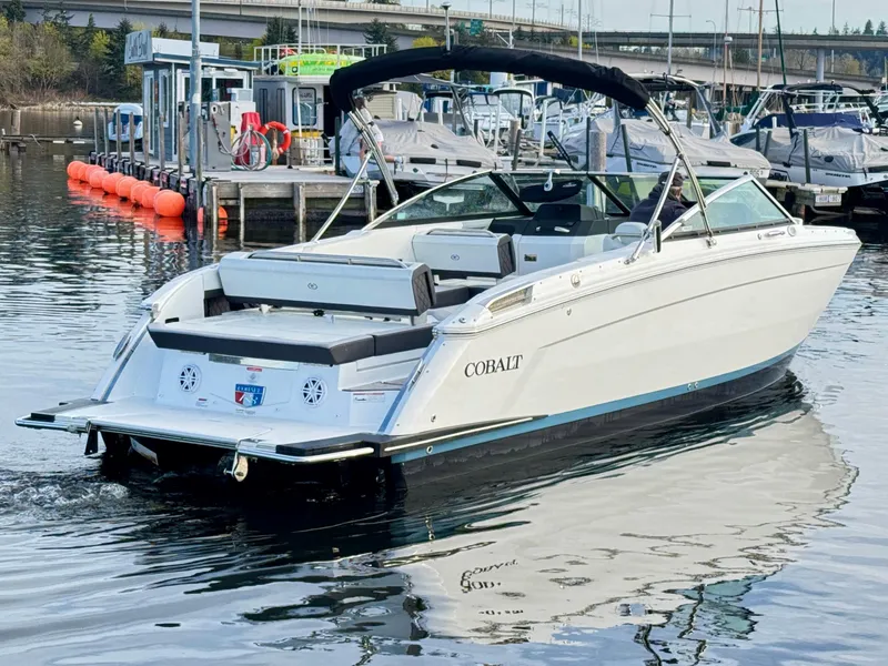 Slide: The Image of 2023 Cobalt R8 boat docked in marina, featuring sleek design and spacious seating. - 18