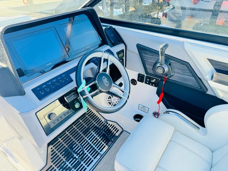 Slide: The Image of 2023 Cobalt R8 boat cockpit with modern steering wheel and dual display screens. - 2