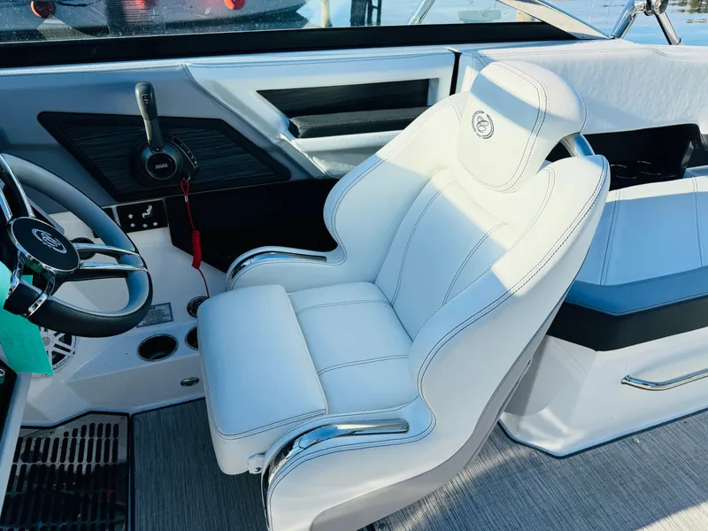 Slide: The Image of 2023 Cobalt R8 boat interior with white captain's seat and steering wheel. - 31