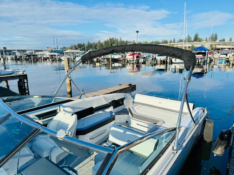 Slide: The Image of 2023 Cobalt R8 boat docked at a marina, featuring sleek design and spacious seating. - 35