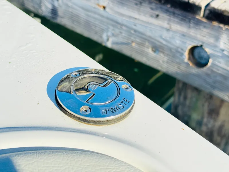 Slide: The Image of Chrome waste cap on 2023 Cobalt R8 boat deck near wooden dock. - 41