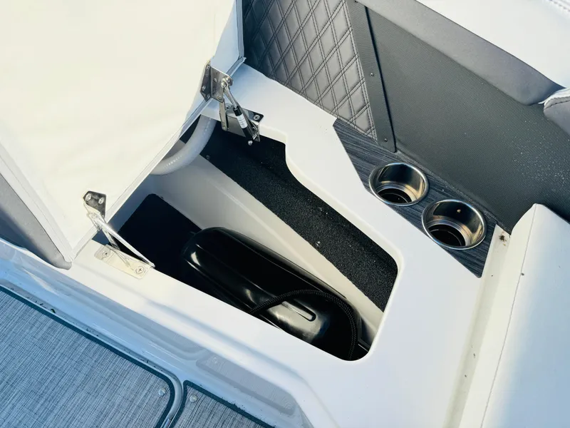 Slide: The Image of 2023 Cobalt R8 boat interior storage compartment with cup holders and quilted paneling. - 43
