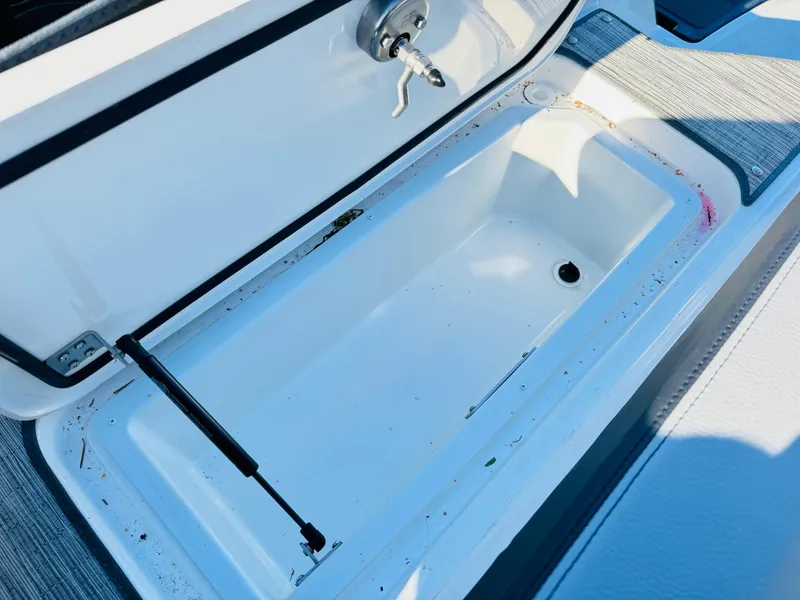 Slide: The Image of Open storage compartment on 2023 Cobalt R8 boat, featuring a clean white interior. - 49