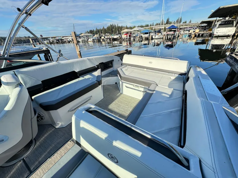 Slide: The Image of 2023 Cobalt R8 boat interior with spacious seating at a marina. - 6