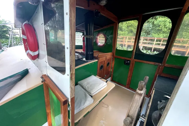 Slide: The Image of Interior of a 1995 Rover Marine Lines Bonny Rover boat with green and wood accents. - 12