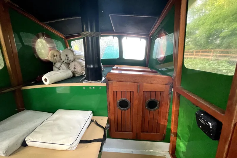 Slide: The Image of Interior of 1995 Rover Marine Lines Bonny Rover boat with green walls and wooden cabinets. - 16