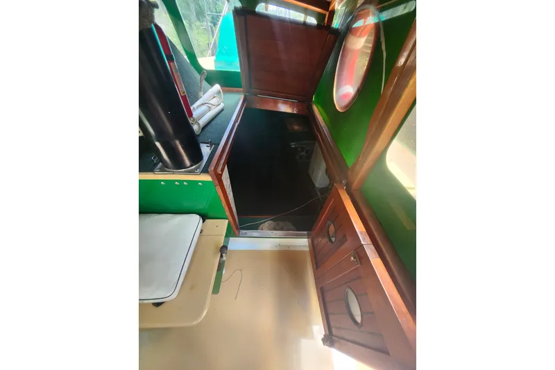 Slide: The Image of Interior of 1995 Rover Marine Lines Bonny Rover boat with wooden cabinetry and seating. - 18
