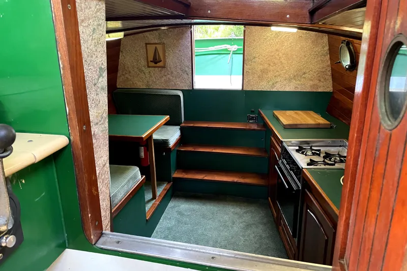 Slide: The Image of Interior of a 1995 Rover Marine Lines Bonny Rover boat with kitchen and seating area. - 19