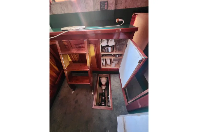 Slide: The Image of Interior of 1995 Rover Marine Lines Bonny Rover with open storage compartments and visible engine parts. - 21
