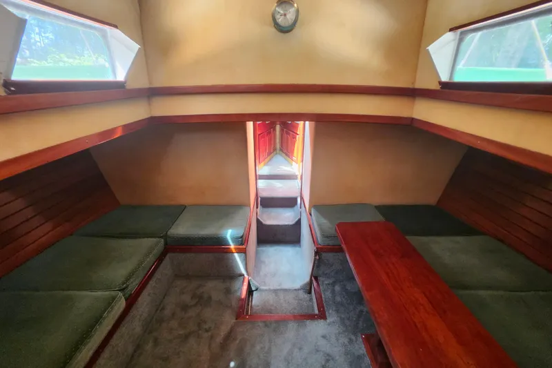 Slide: The Image of Interior of 1995 Rover Marine Lines Bonny Rover boat with cozy seating and wooden accents. - 30
