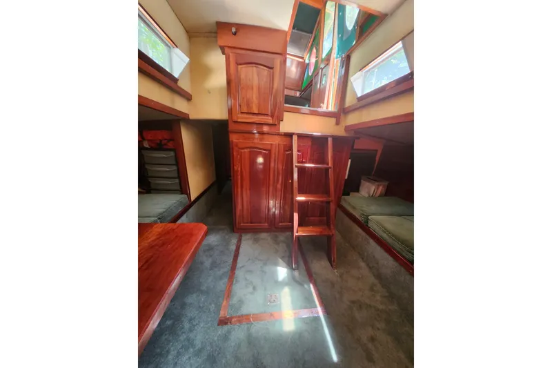 Slide: The Image of Interior of 1995 Rover Marine Lines Bonny Rover boat with wooden cabinetry and seating. - 32