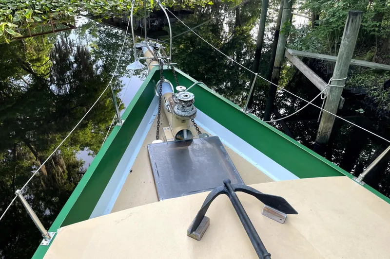 Slide: The Image of Bow of 1995 Rover Marine Lines Bonny Rover boat with anchor and lush surroundings. - 35