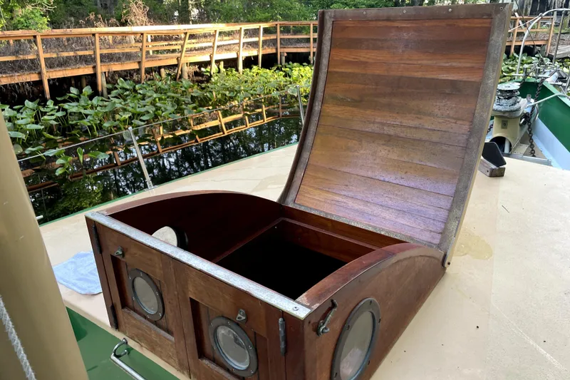 Slide: The Image of Wooden hatch on 1995 Rover Marine Lines Bonny Rover boat, near lush waterway. - 38