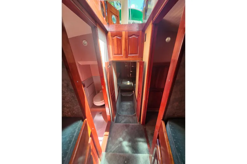 Slide: The Image of Interior of 1995 Rover Marine Lines Bonny Rover boat, featuring wooden cabinetry and compact bathroom. - 39