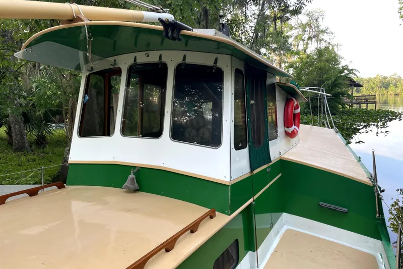 Slide: The Image of 1995 Bonny Rover boat by Rover Marine Lines, docked near lush greenery. - 4