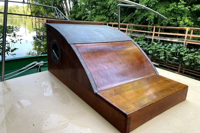 Slide: The Image of Wooden deck of 1995 Rover Marine Lines Bonny Rover boat by a lush riverside. - 44