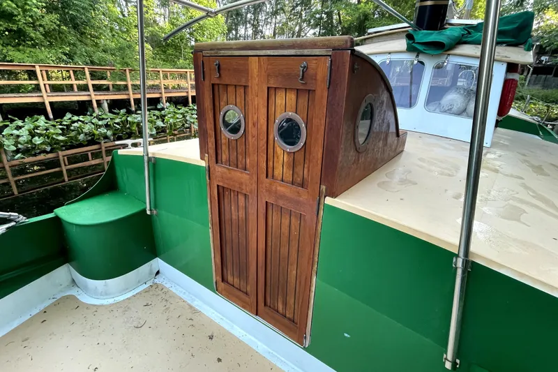 Slide: The Image of 1995 Rover Marine Lines Bonny Rover boat with wooden cabin doors and green exterior. - 45