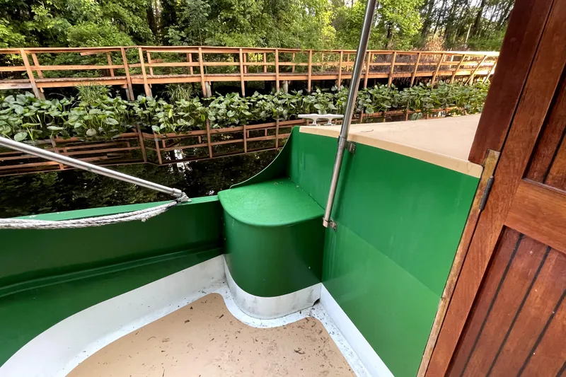 Slide: The Image of Green and beige deck of 1995 Bonny Rover boat by Rover Marine Lines, near wooden walkway. - 46