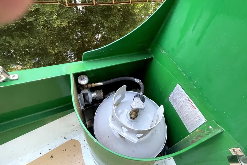 Slide: The Image of Green compartment on 1995 Rover Marine Lines Bonny Rover with propane tank and gauge. - 47
