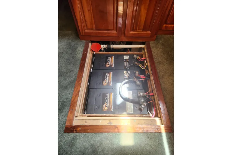 Slide: The Image of Battery compartment of a 1995 Rover Marine Lines Bonny Rover, featuring multiple connected batteries. - 53