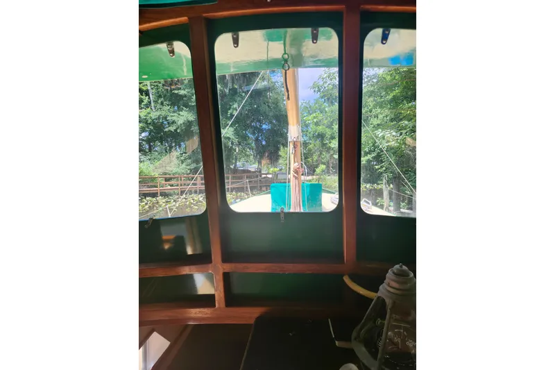 Slide: The Image of Interior view of 1995 Bonny Rover boat by Rover Marine Lines, showcasing lush greenery outside. - 56
