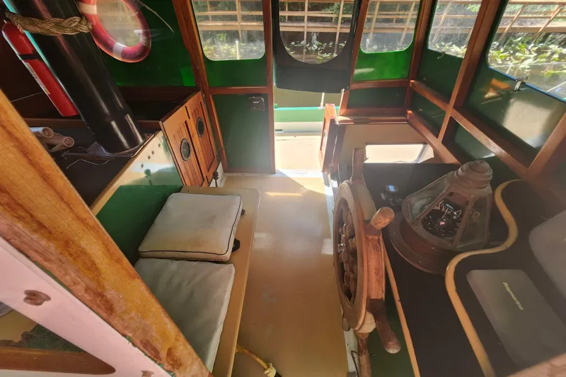 Slide: The Image of Interior of 1995 Rover Marine Lines Bonny Rover boat with wooden steering wheel and seating. - 57