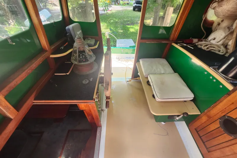Slide: The Image of Interior of a 1995 Rover Marine Lines Bonny Rover boat with wooden accents and seating. - 58