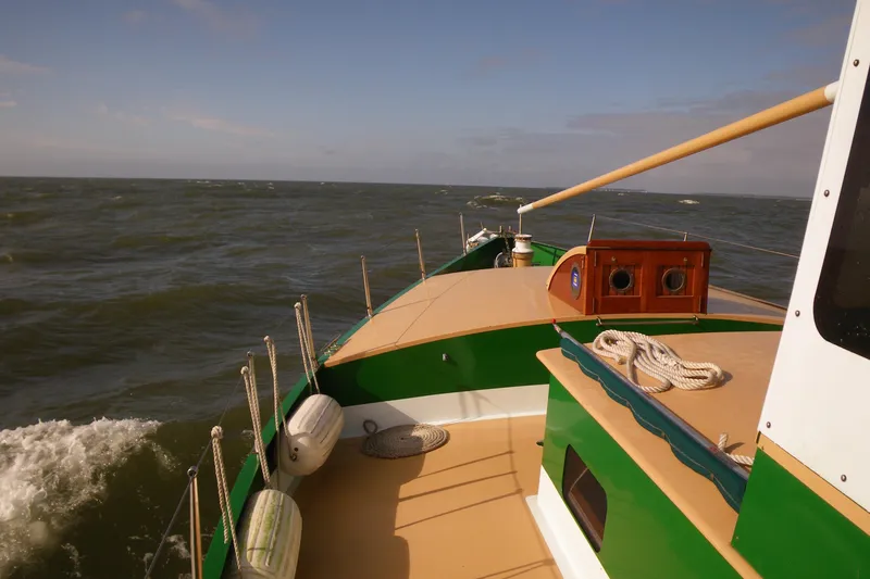 Slide: The Image of 1995 Bonny Rover boat navigating open sea under clear skies. - 61