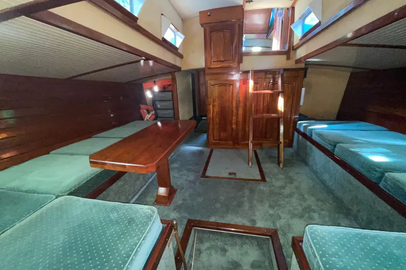 Slide: The Image of Interior of 1995 Rover Marine Lines Bonny Rover boat with wooden furnishings and seating. - 7