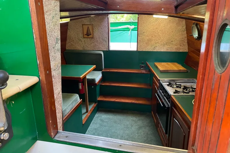 Slide: The Image of Interior of 1995 Rover Marine Lines Bonny Rover boat with kitchen and seating area. - 8