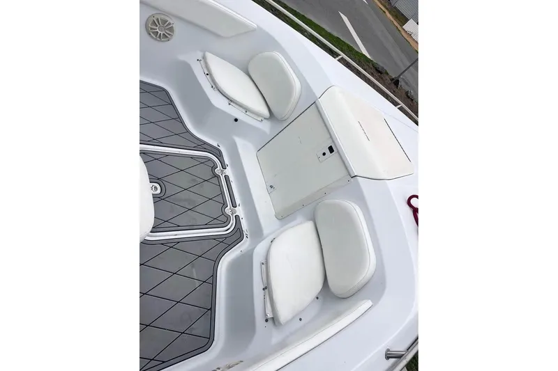 Slide: The Image of 2003 Sports Fisher 340 boat interior with white seating and deck details. - 10