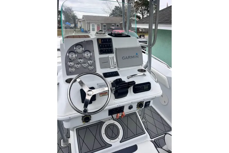 Slide: The Image of 2003 Sports Fisher 340 boat dashboard with Garmin navigation system and steering wheel. - 3