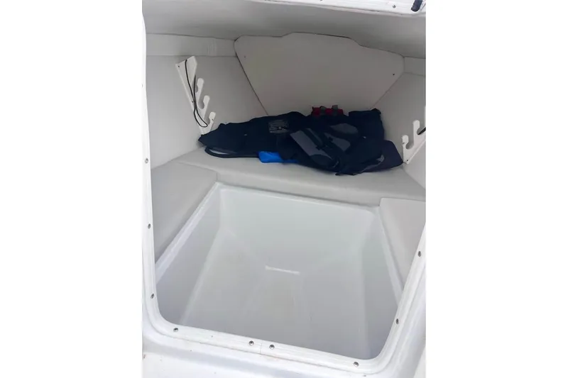 Slide: The Image of Interior cabin of 2003 Sports Fisher 340 boat, featuring storage space and seating. - 9