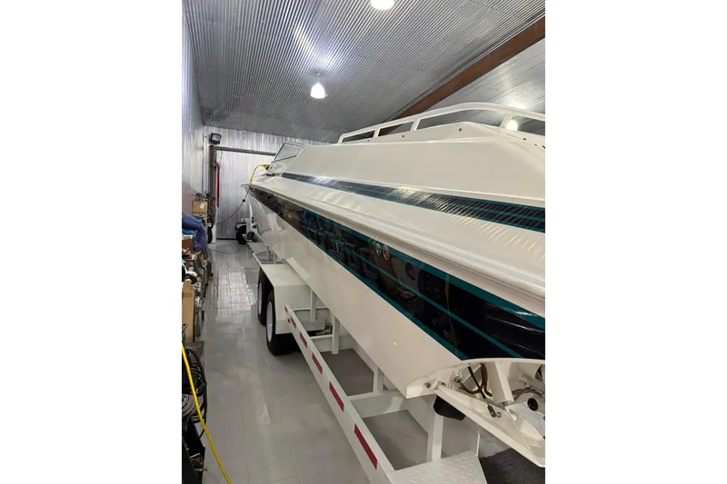 Slide: The Image of 2000 Fountain 47 Lightning boat in storage, showcasing sleek design and vibrant detailing. - 2